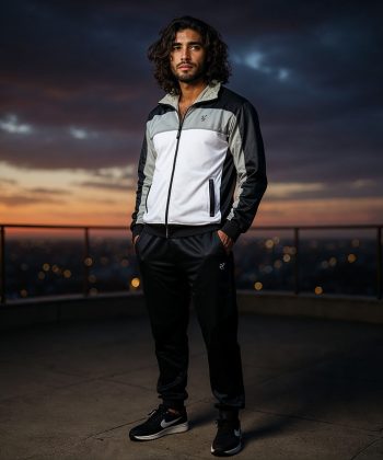 Side profile of a man in the Chroma Mens Tracksuit Pakistan (black, grey, white).