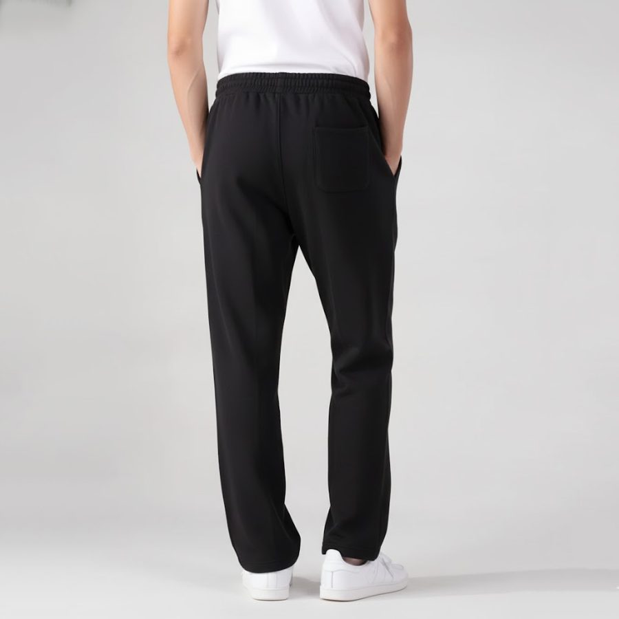 Back view of black mens terry trousers showing the back pocket and relaxed fit.
