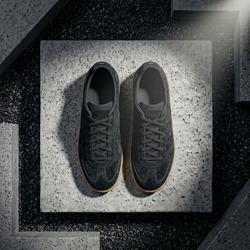 Top-down overhead view of Asphalt black suede sneakers showing the secure lace-up closure and soft inner lining