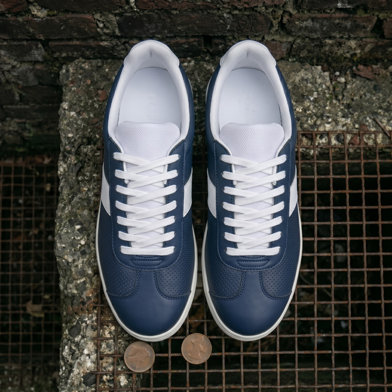 Top-down perspective of Retro Glide navy leather sneakers showcasing the cushioned white interior and symmetrical lacing.
