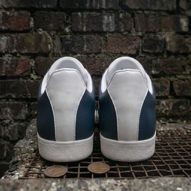 Back view of the Retro Glide navy leather sneakers showing the white heel counter and durable rubber sole